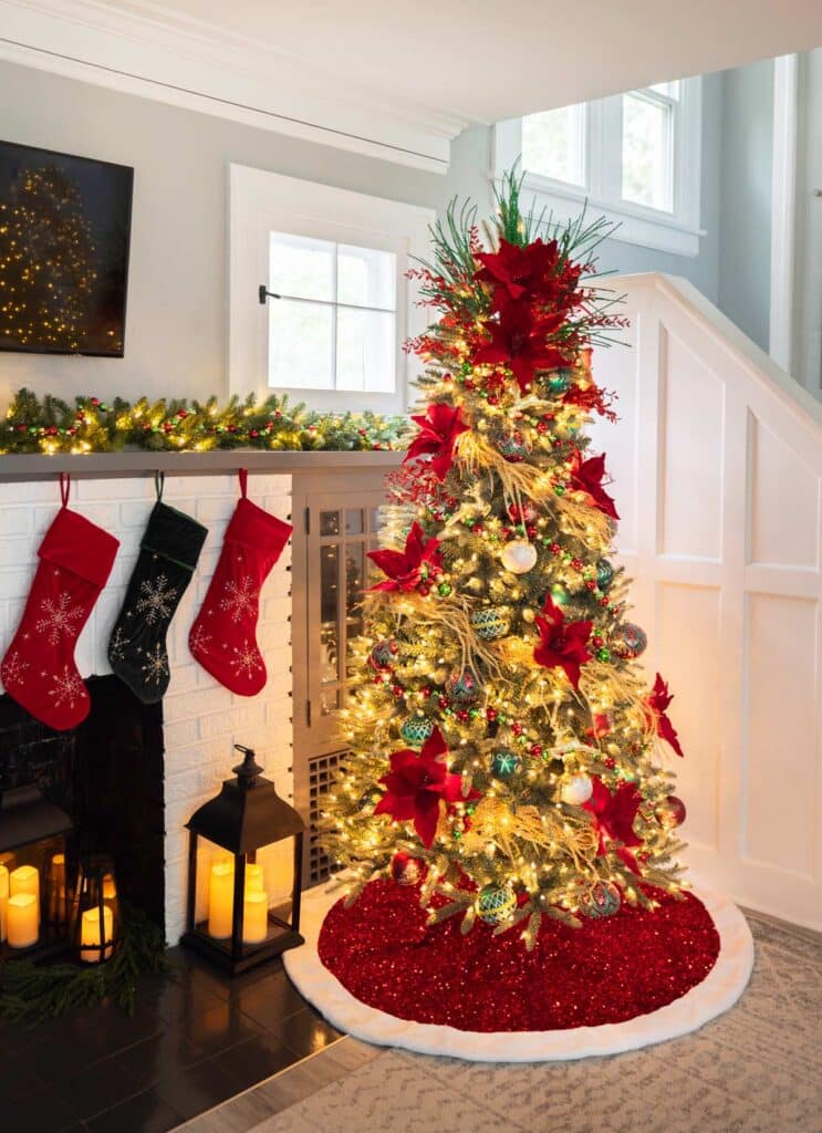 Elegant Christmas Tree with Poinsettias and Festive Decor